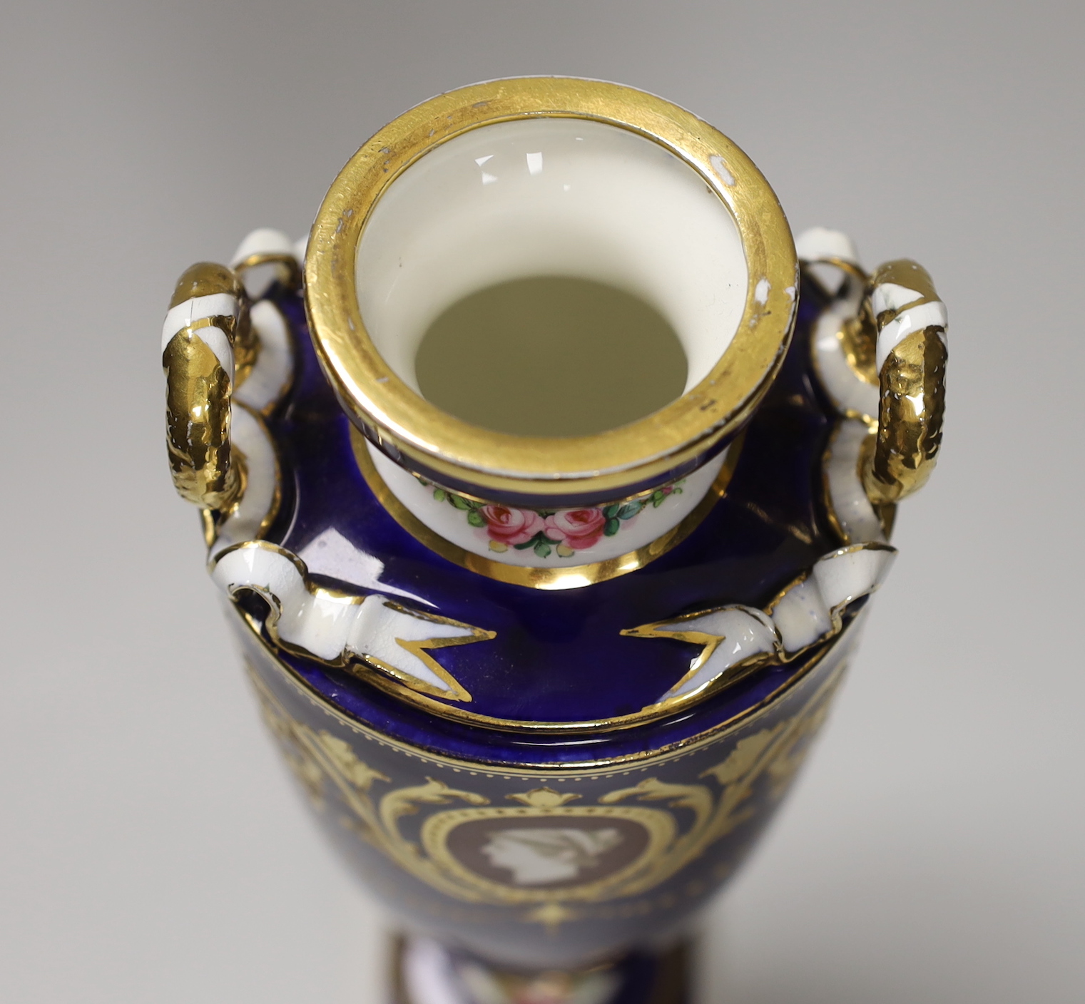 A Minton two handled vase painted with portrait medallions on a blue and gilt ground, 28cm high
